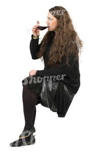 young woman sitting in a cafe and drinking wine