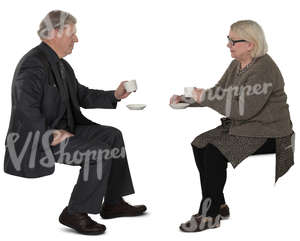 elderly couple sitting in a cafe and drinking coffee