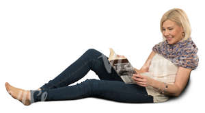 woman sitting on a sofa and reading a book