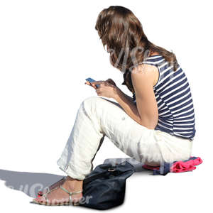 woman sitting on the stairs and looking at her phone