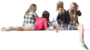 four girls sitting on a balustrade