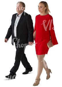 man and woman in formal clothing walking hand in hand