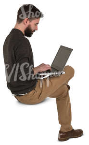 man sitting and working with a laptop