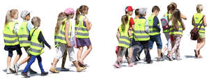 group of children wearing reflector vests walking