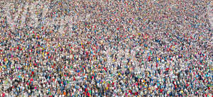 a large crowd standing and listening to a concert