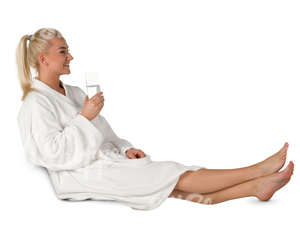 woman in a white bathrobe sitting in a spa