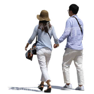 asian couple walking hand in hand on a sunny street