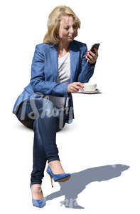 woman sitting in a street cafe and drinking coffee