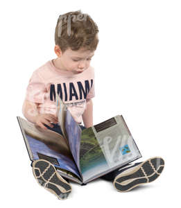 boy sitting on the floor with a book