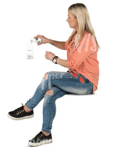 woman sitting in a cafe and pouring herself some water