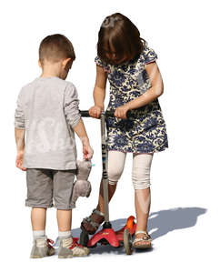 boy and girl playing together with a scooter