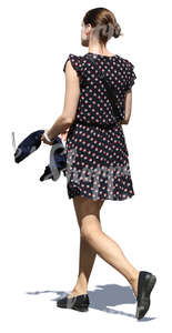 woman in a short summer dress walking in sunlight