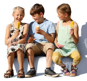 three children sitting and eating ice cream