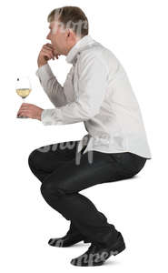 man sitting in a cafe and drinking white wine