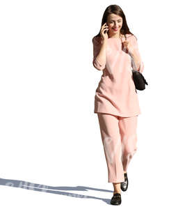 woman in a pink costume walking and talking on the phone