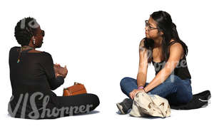 asian and african woman sitting and talking