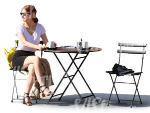 woman sitting in a street cafe