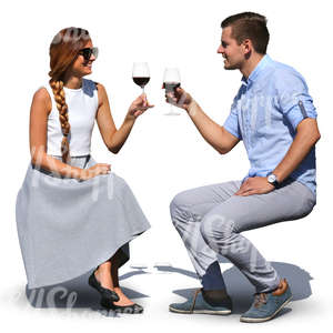 man and woman sitting in a cafe and drinking wine