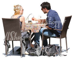 man and woman sitting in a cafe and eating