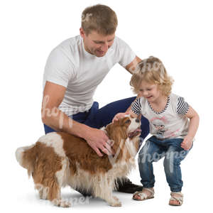 father and daughter playing with a dog