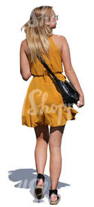 woman in a yellow summer dress walking