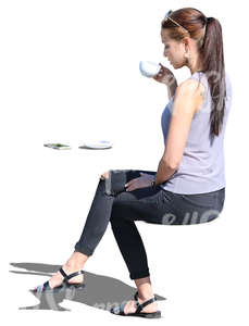 woman sitting in a cafe and drinking coffee