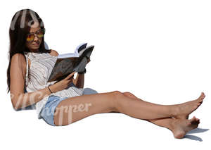 woman lying on lounge chair and reading a book
