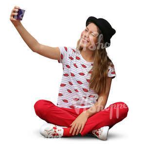 girl sitting and taking a selfie