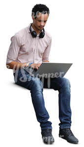 african man sitting and working with a laptop