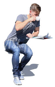 man sitting in a cafe and drinking coffee.