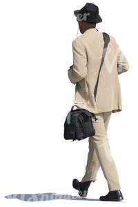 african man in a beige suit walking