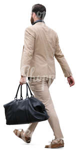 man in a beige suit carrying a bag