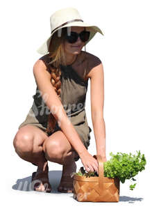 woman with a herbs basket squatting