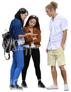 group of three people standing and looking at smth on the phone