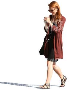 woman walking and looking at her phone