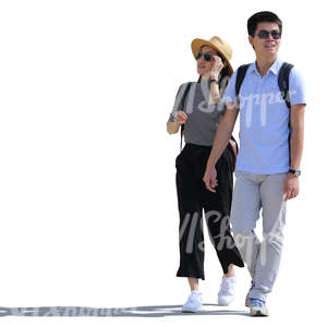 backlit asian couple walking on the street