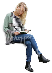 blond woman sitting and reading a book