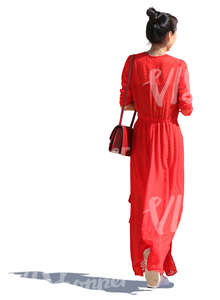 asian woman in a long red dress walking