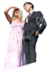 couple in party clothes standing on a balcony
