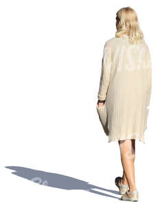 woman in a beige cardigan walking