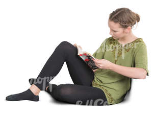 teenage girl sitting on a sofa and reading a book