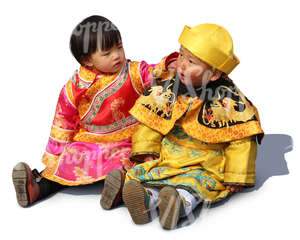 two chinese children sitting on the ground