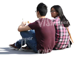 asian couple sitting on the ground