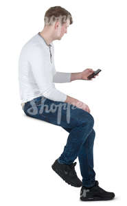 man sitting on a bar stool and texting