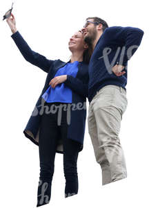 man and woman standing on a balcony and taking a selfie