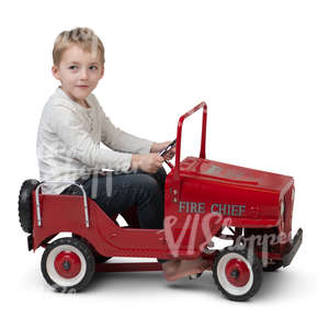 little boy driving a toy car