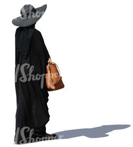 woman with a big hat and black cape walking