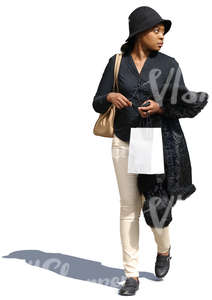 black woman walking with a shopping bag in hand
