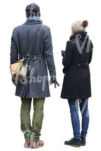 man and woman in autumn coats standing