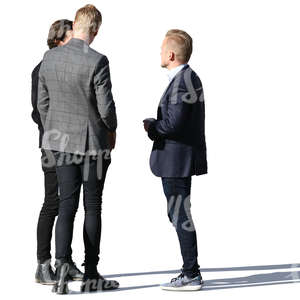 group of three young men standing and talking